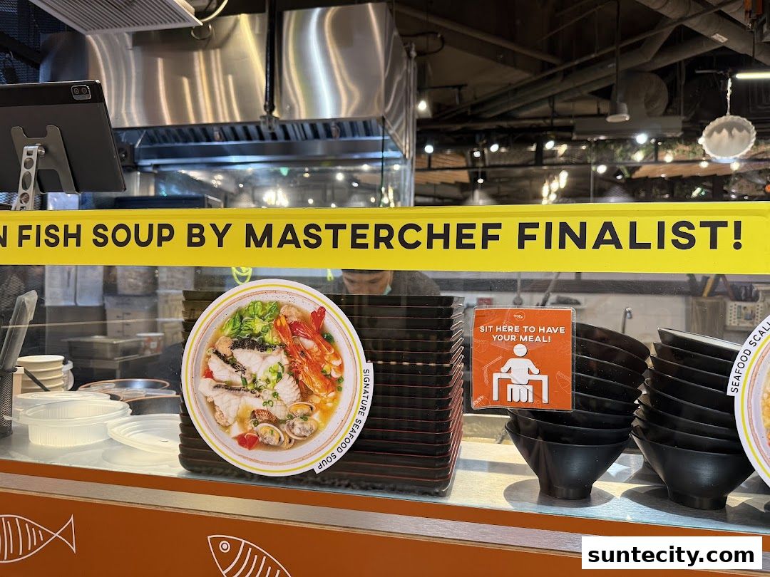 A display counter at SoupCup Suntec City featuring a signature seafood soup and bowls.