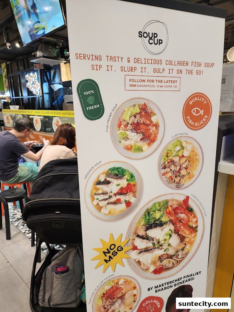 A display board for SoupCup Suntec City showcasing various collagen fish soup dishes.