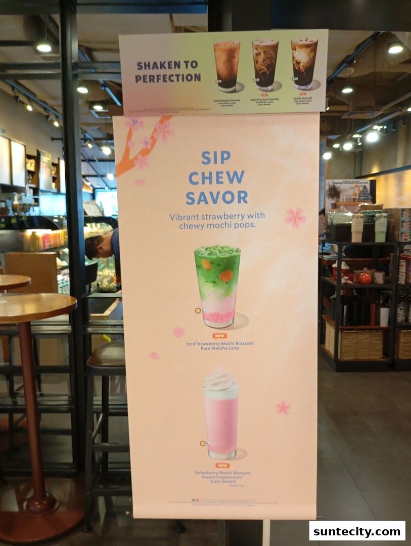 A promotional banner for Starbucks featuring new strawberry mochi blossom drinks.