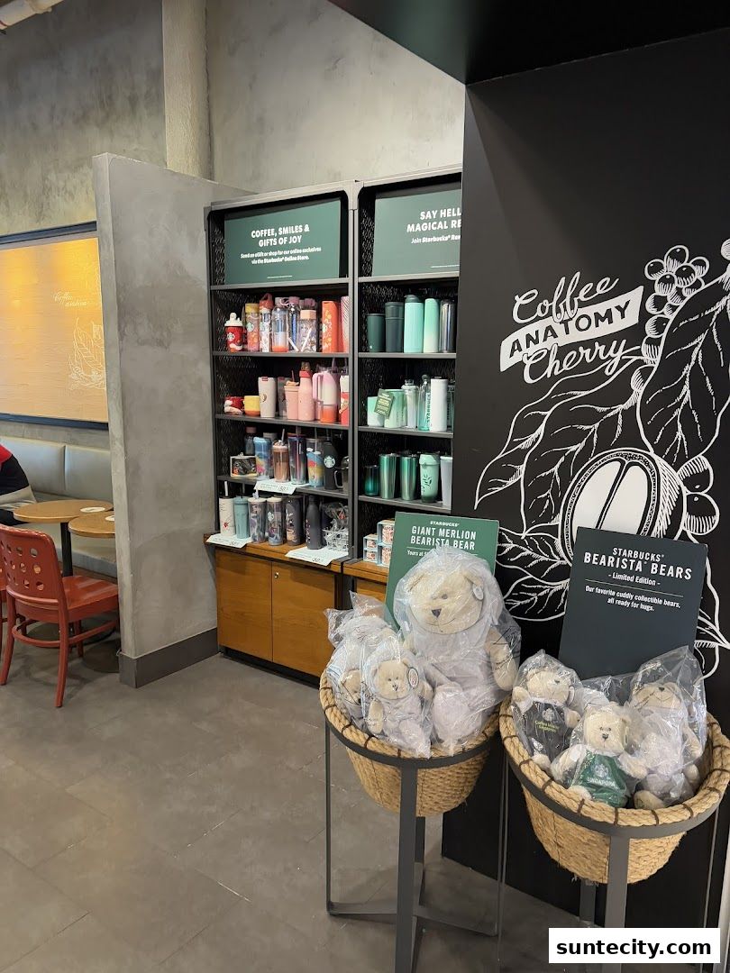 Starbucks store interior featuring merchandise shelves, seating area, and promotional displays of teddy bears.