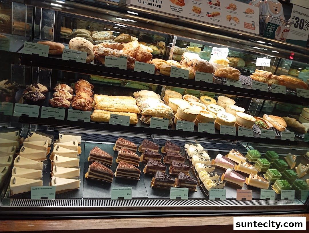 A display case filled with various pastries, cakes, and savory items at Starbucks.