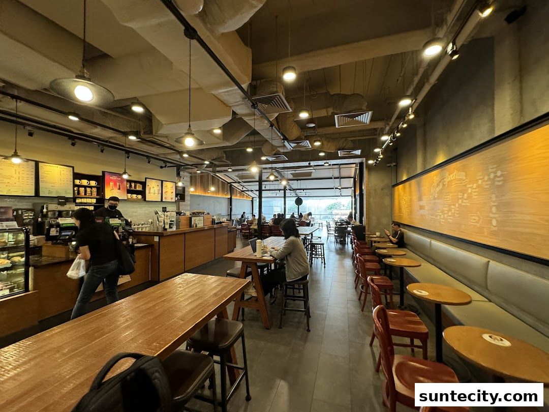Interior view of a Starbucks cafe with customers and staff at the counter.