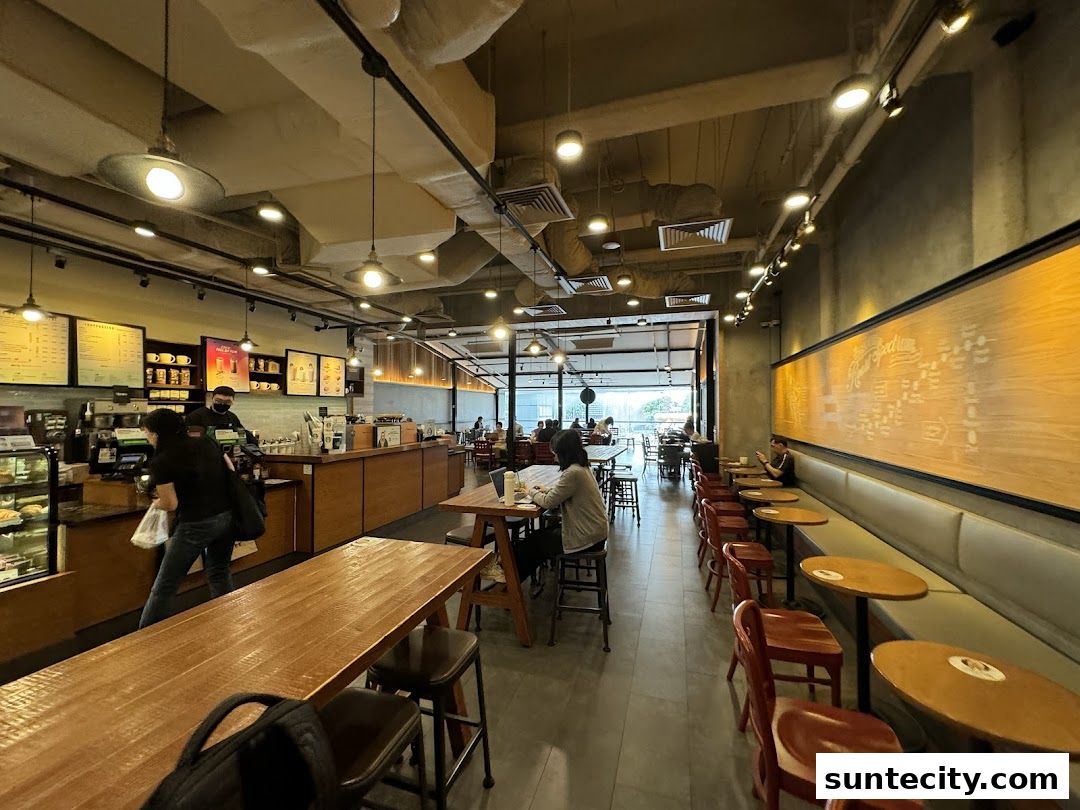 Interior view of a Starbucks cafe with seating areas and a counter.