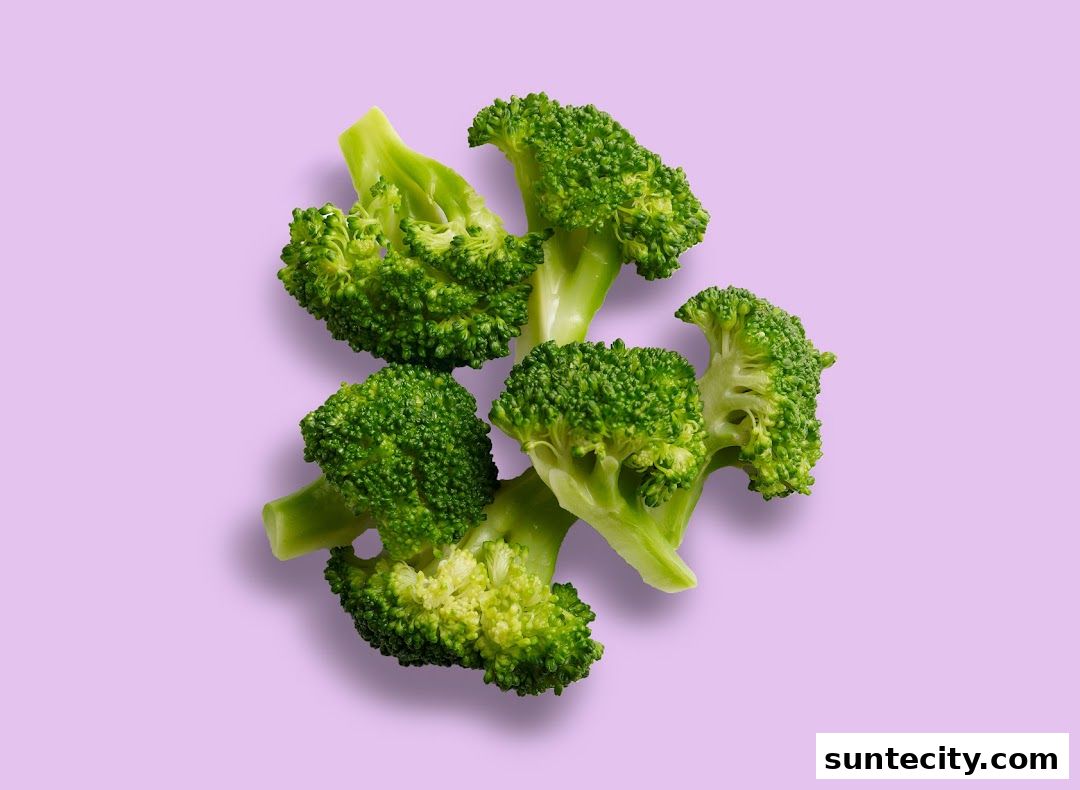 Fresh broccoli florets are artfully arranged on a light purple background.