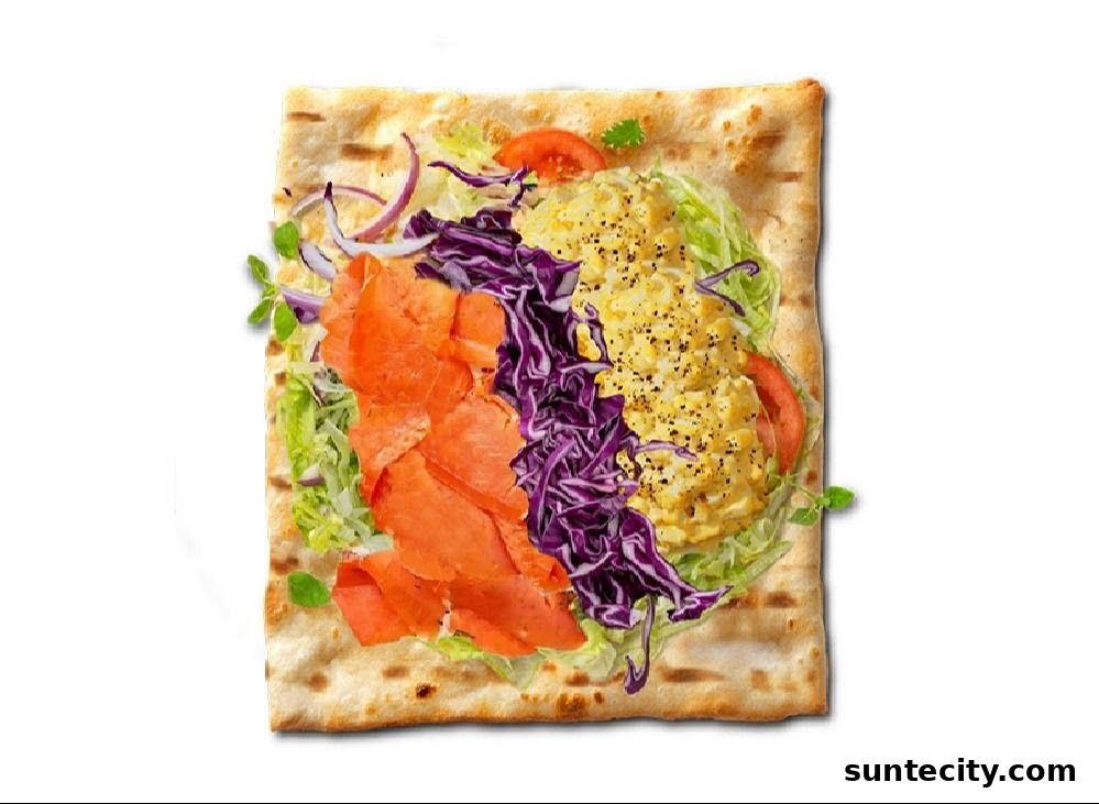A flatbread wrap filled with smoked salmon, shredded cabbage, lettuce, onions, and scrambled eggs.