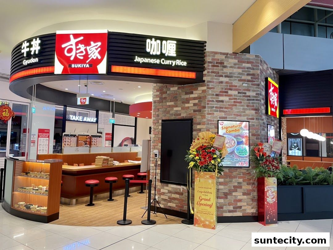 The Sukiya Gyudon and Japanese Curry Rice shop front with a counter and seating.