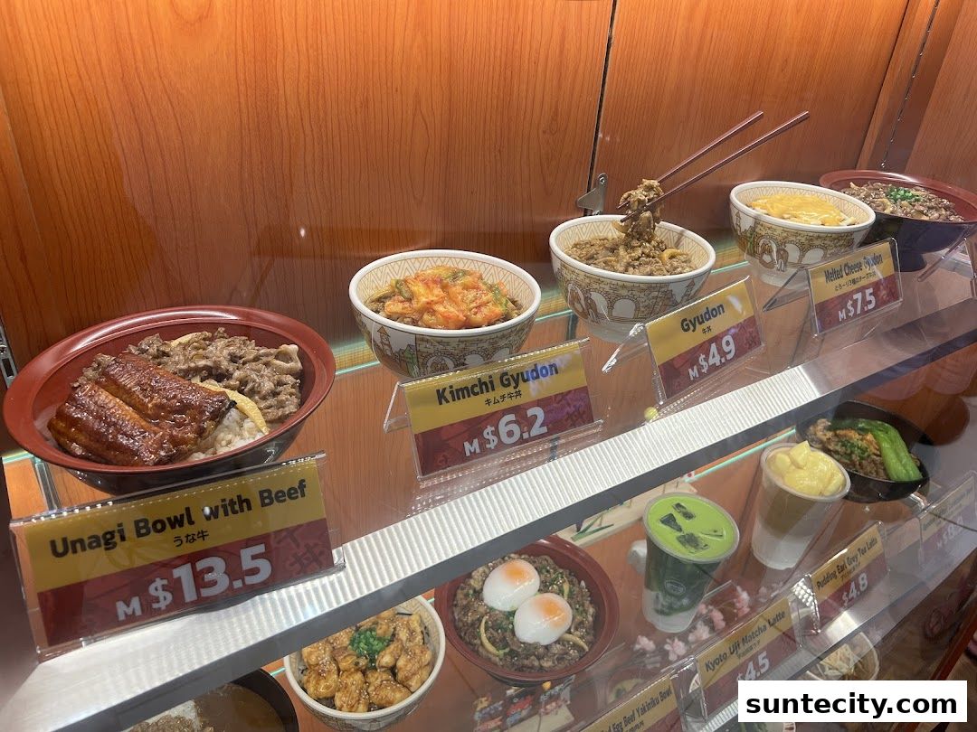 Display case featuring realistic food models of Japanese rice bowls and drinks.