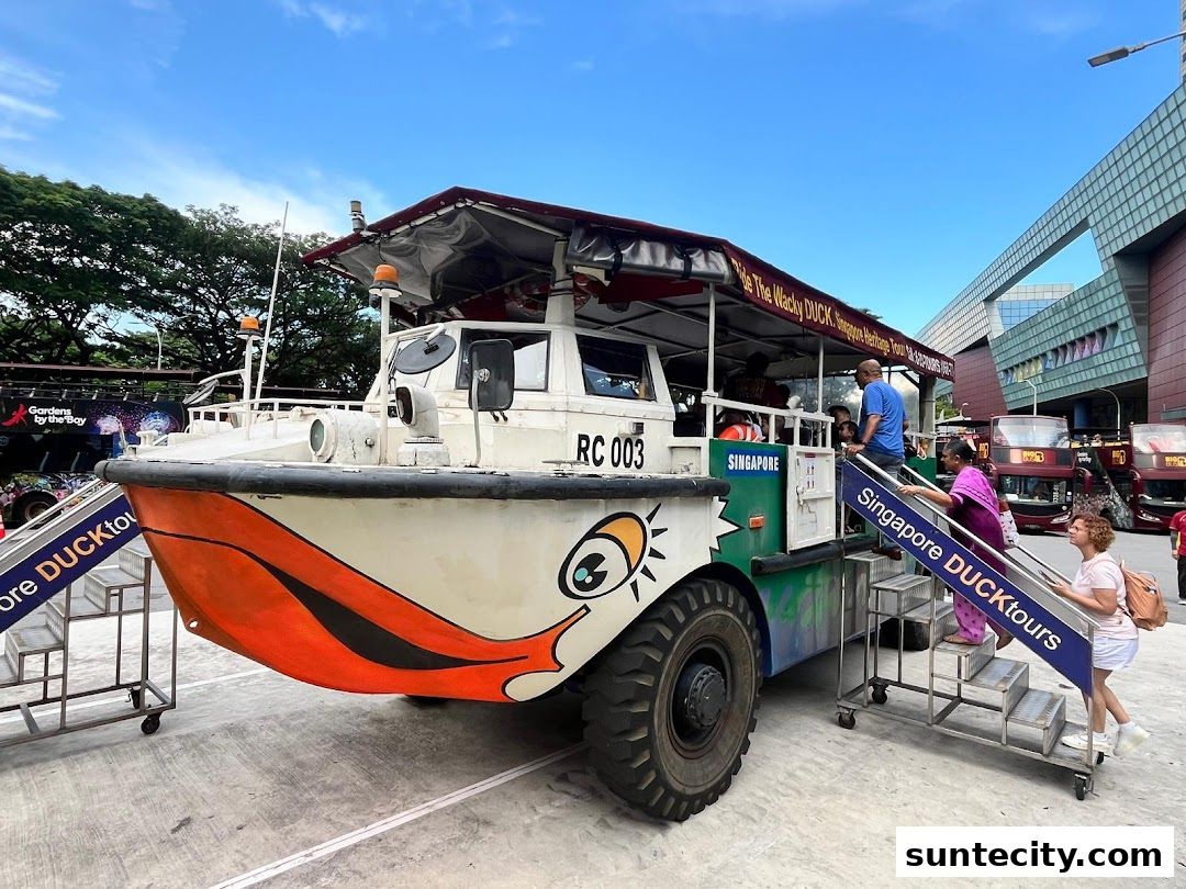 A unique amphibious vehicle, the Singapore DUCKtours, is boarding passengers outside Suntec City.
