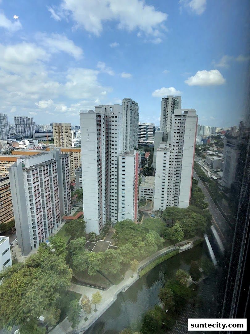 An aerial view of a city skyline with tall buildings and a canal.