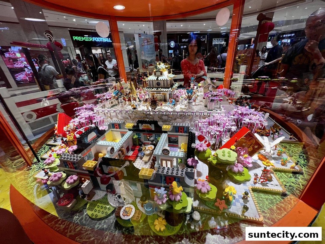A detailed Lego display featuring intricate buildings and miniature figures, showcased in a shop window.