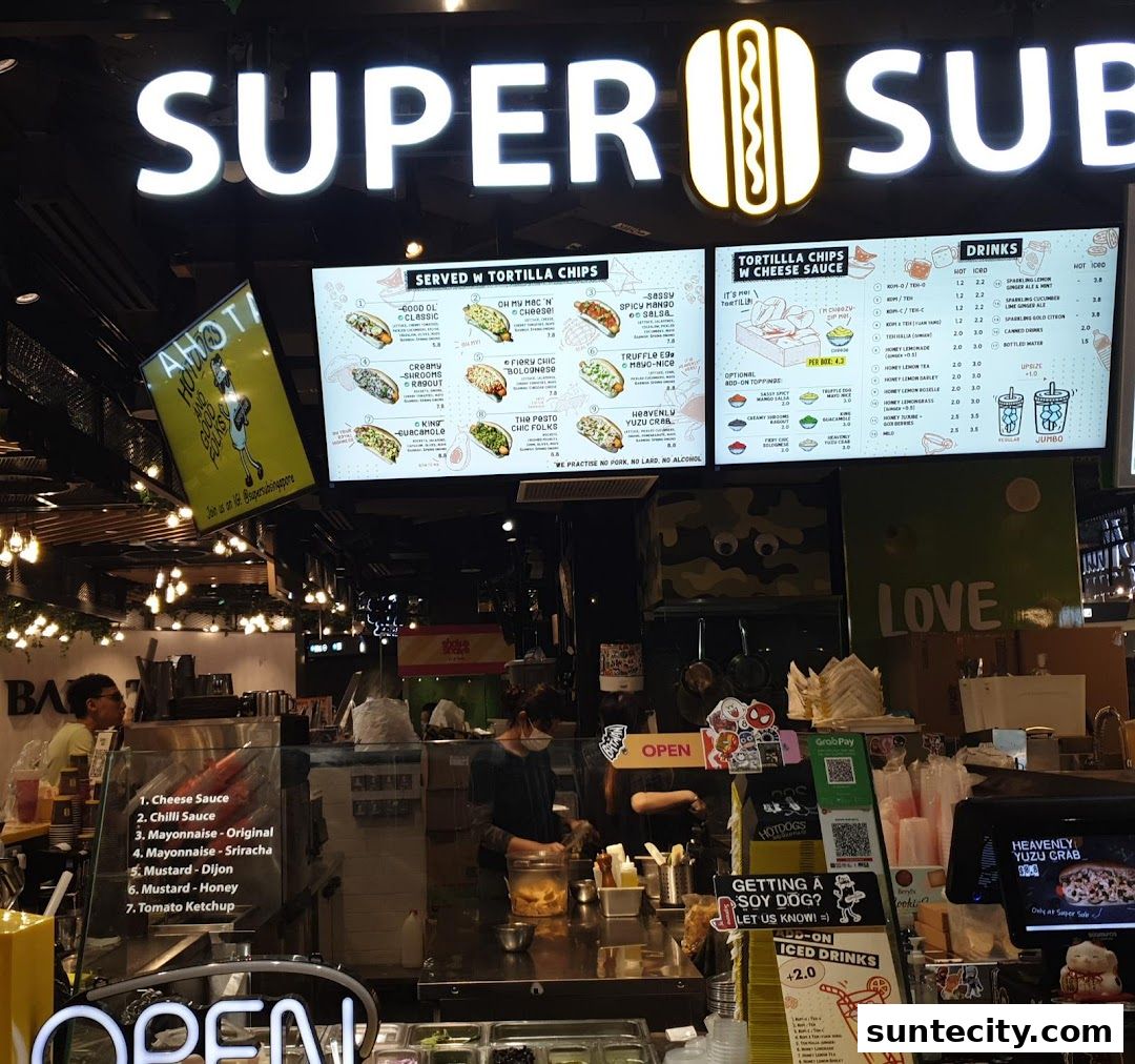 Super Sub Hotdogs & Coffee shop front with a bright illuminated sign and menu boards.