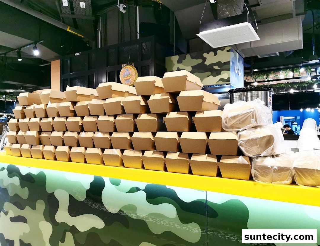 A counter stacked with many takeaway food boxes and some bagged items.