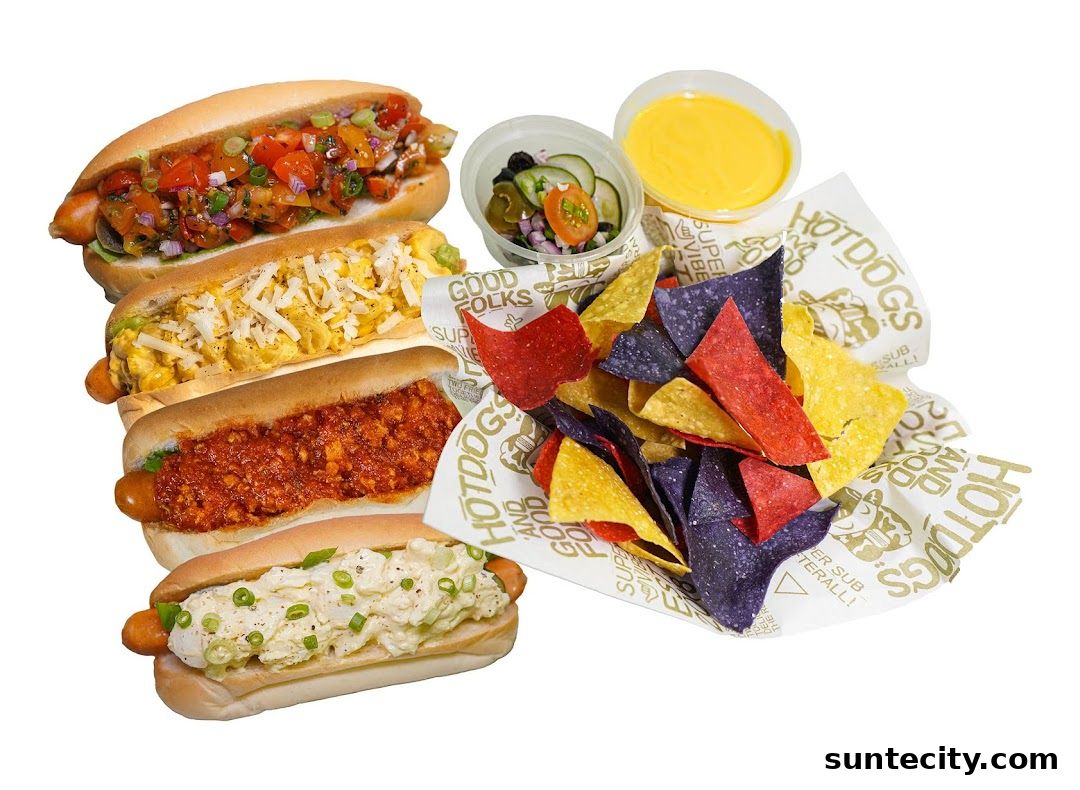 A selection of four gourmet hot dogs and a side of tortilla chips with cheese dip.