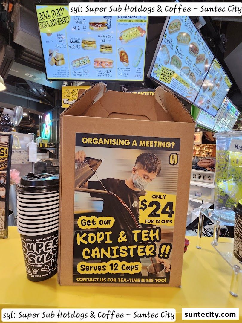 A display of hotdogs, coffee, and a Kopi & Teh canister promotion at Super Sub.
