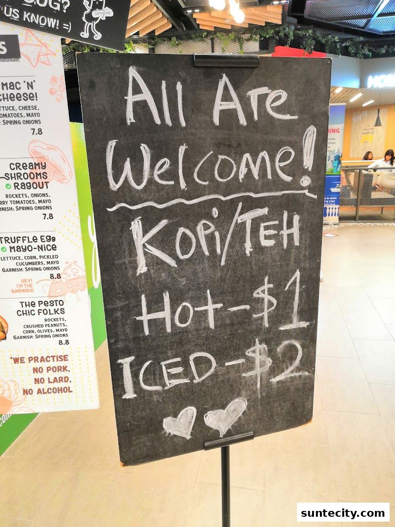 A chalkboard sign announces 'All Are Welcome!' with prices for Kopi/Teh.