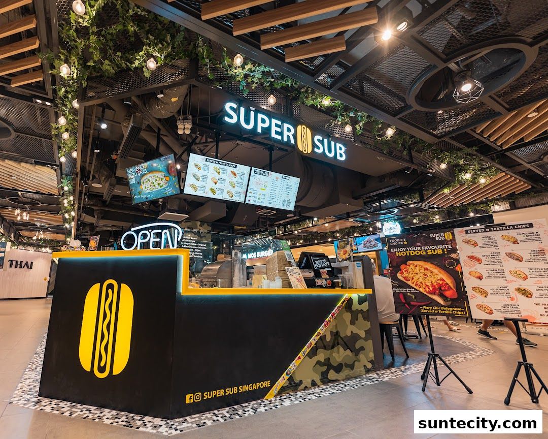 A Super Sub shop counter with a large hotdog logo and menu boards displayed.