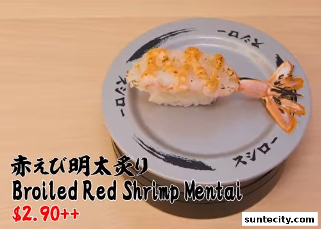 A plate of broiled red shrimp mentai sushi with its tail on a rotating base.