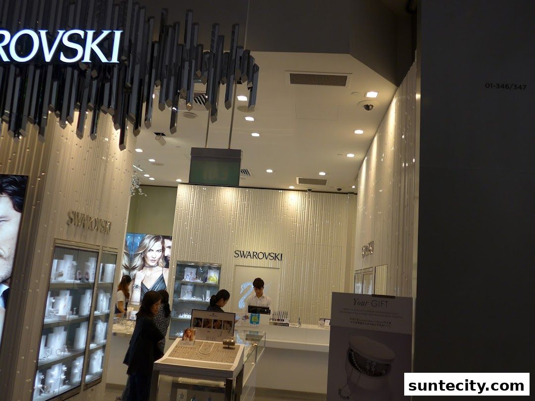 The interior of a Swarovski store with displays of jewelry and a sales counter.