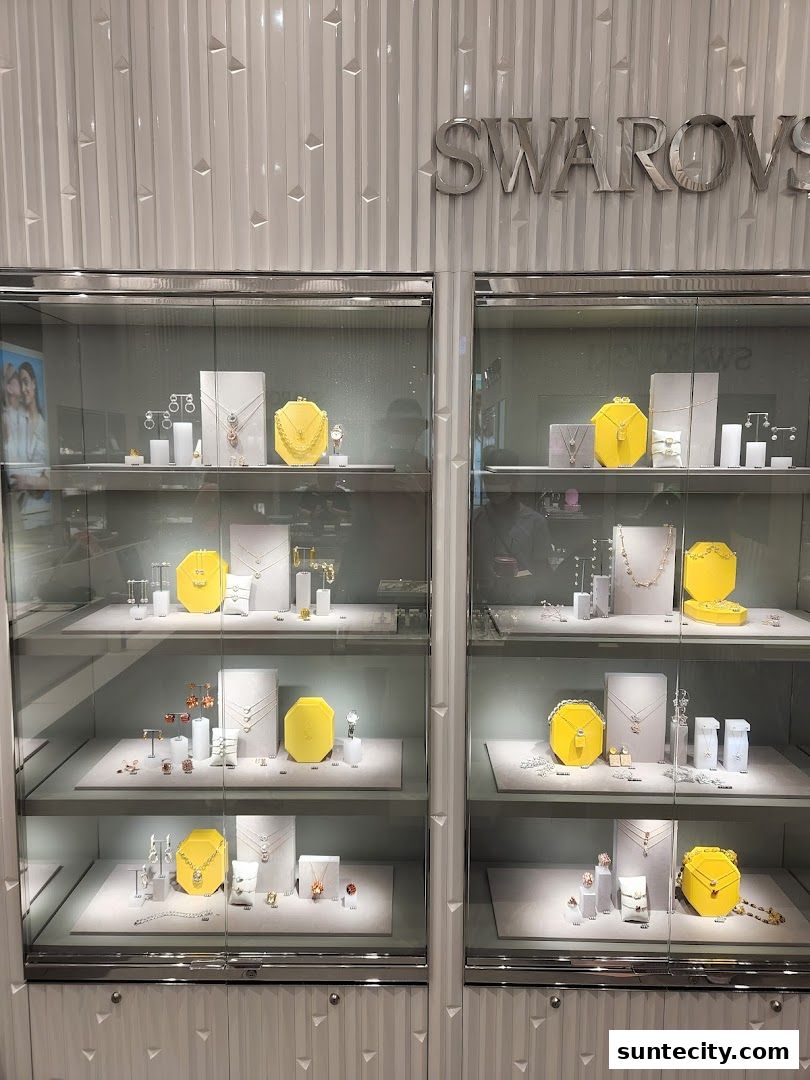 Swarovski shop interior with display cases showcasing jewelry and accessories.