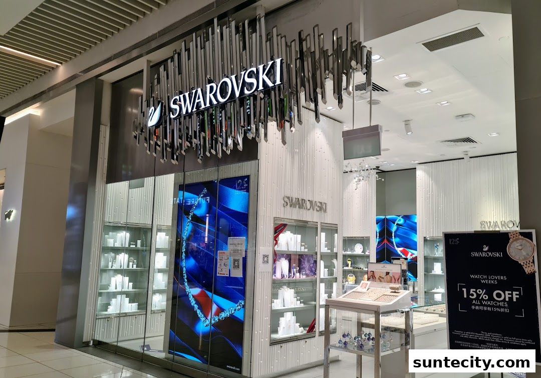The exterior of a Swarovski jewelry store with sparkling displays and a promotional sign.