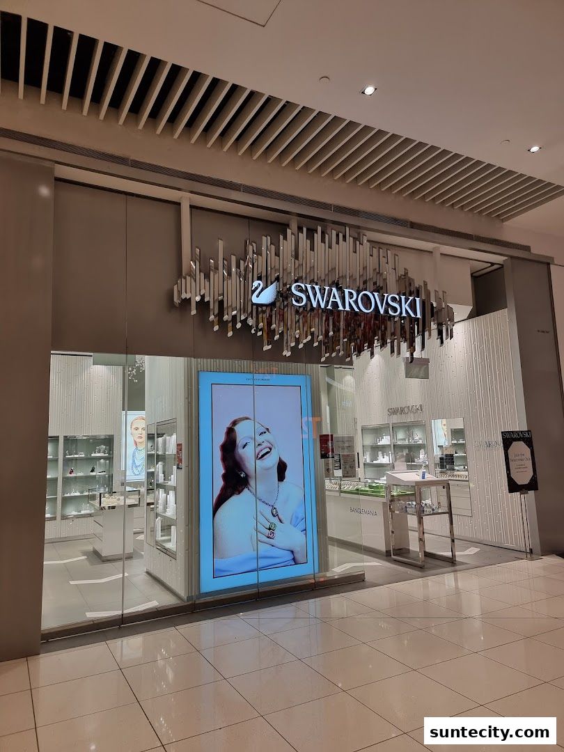 The exterior of a Swarovski jewelry store with a large display window featuring a model.