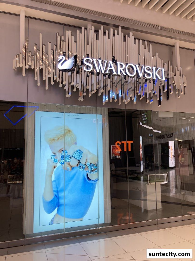The exterior of a Swarovski store with a large illuminated advertisement featuring jewelry.