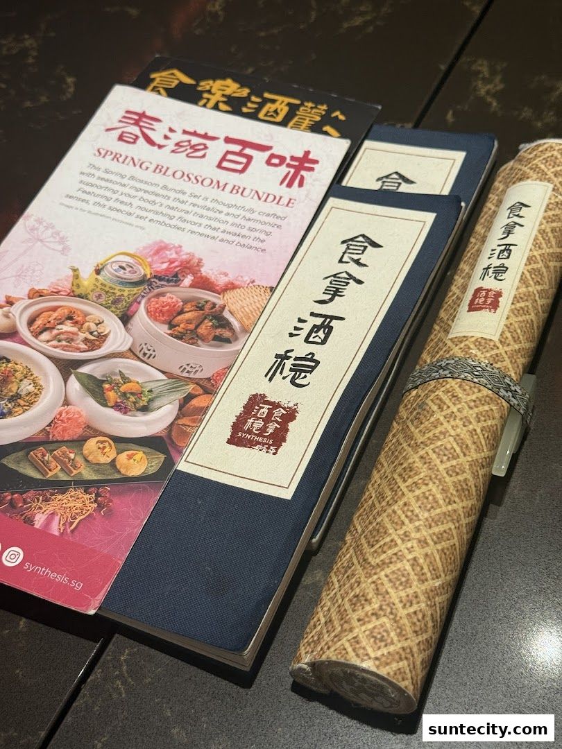 A menu and rolled scroll from Synthesis, a Chinese medical hall inspired restaurant and cocktail bar.
