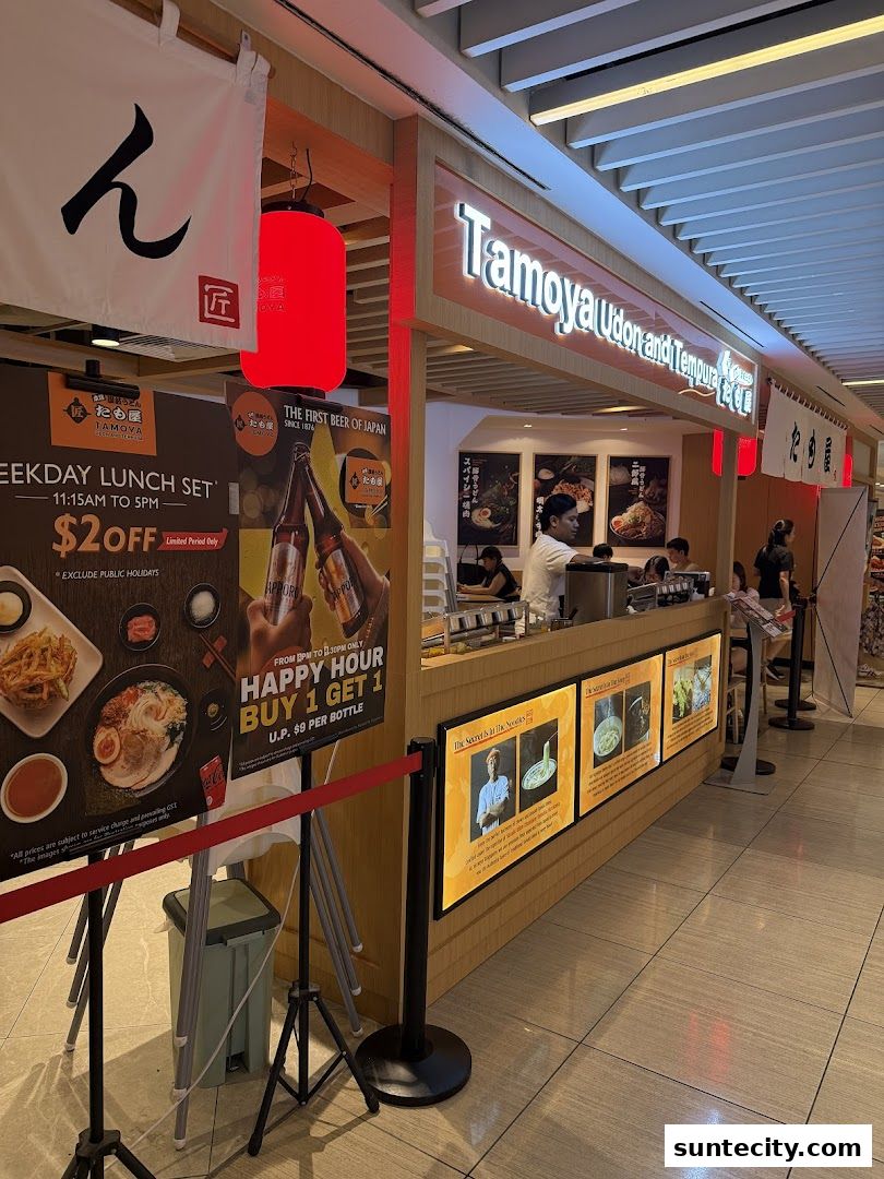 The exterior of Tamoya Udon and Tempura shop with promotional posters and signage.