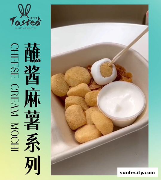 A bowl of mochi with a side of cream and a topping being dipped with a stick.