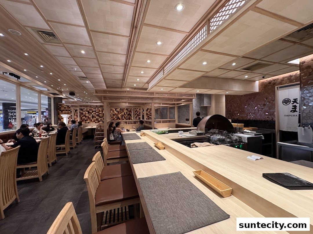 Interior view of Tempura Makino restaurant with diners seated at tables and a counter.