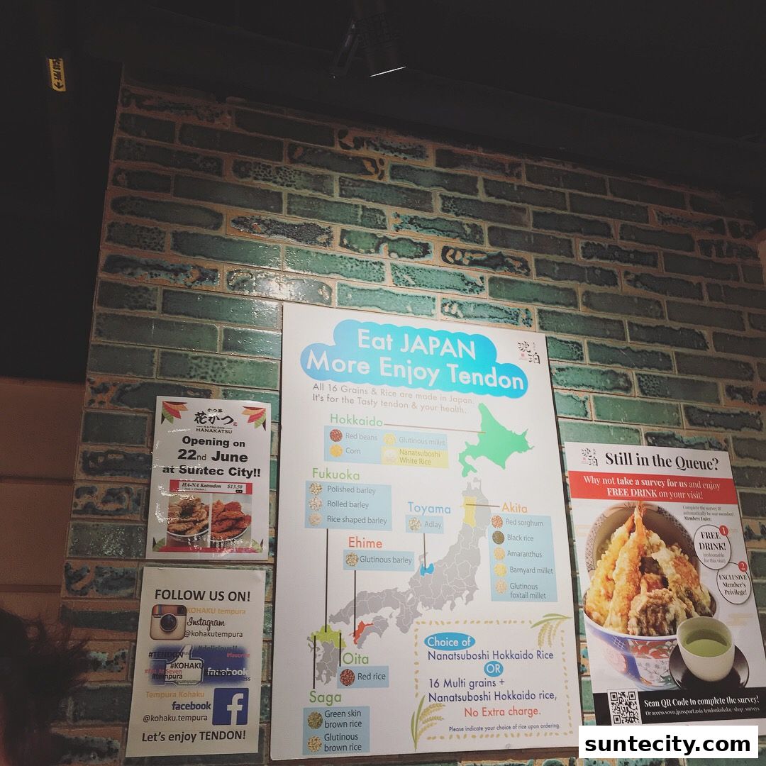 A wall display at Tendon Kohaku featuring a map of Japan highlighting rice varieties and a promotion for a free drink.