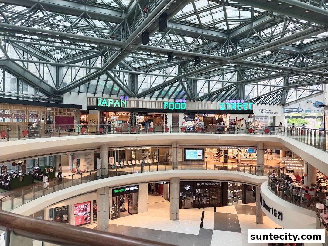 A multi-level shopping mall interior with various shops and a 'Japan Food Street' section.