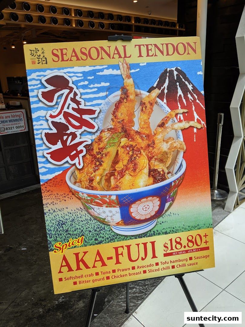 A sign advertising a spicy Aka-Fuji Tendon with various ingredients and a price.