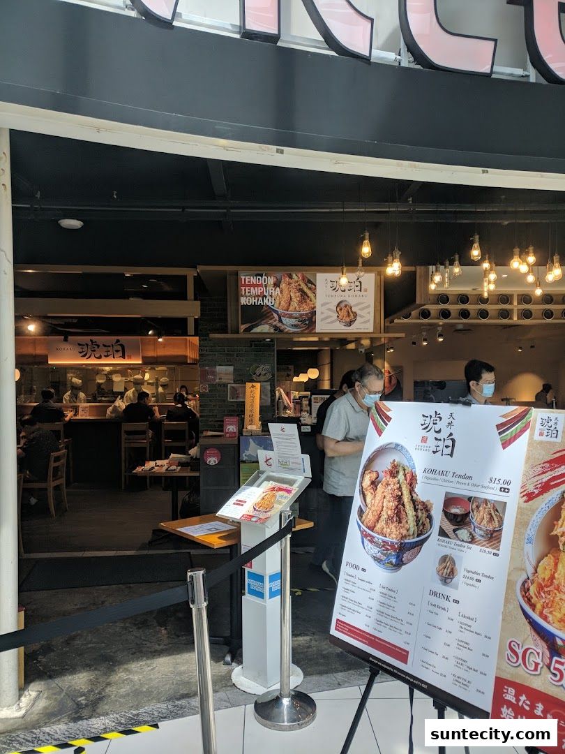 The entrance of Tendon Kohaku restaurant with a menu displayed outside.