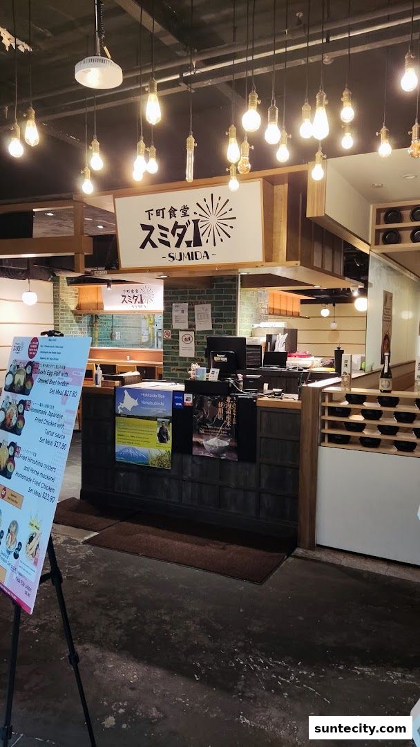 The entrance of a Japanese restaurant with a menu board and decorative lighting.