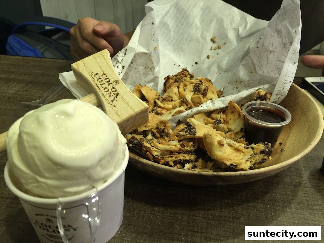 A scoop of ice cream and a dessert with a wooden mallet at The Cocoa Trees.