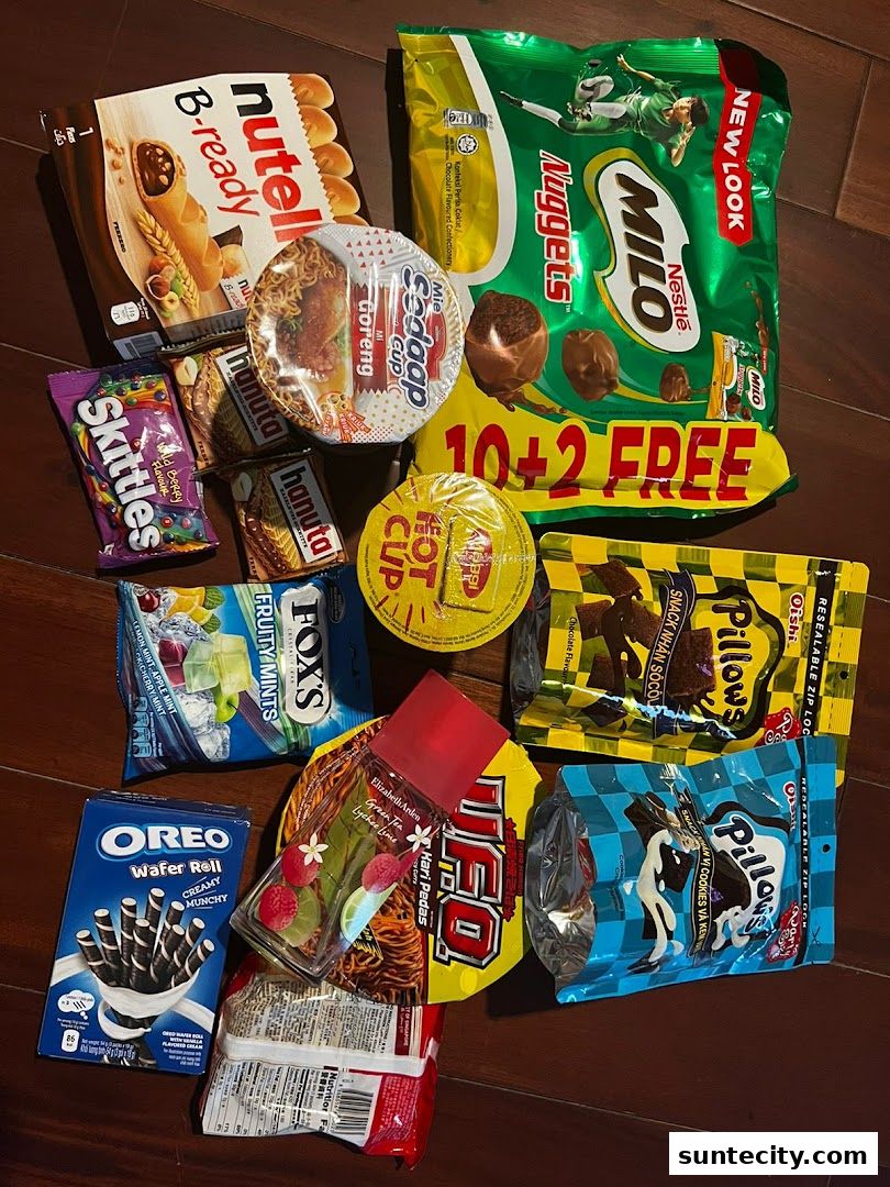 A collection of assorted snacks and confectionery items including Milo Nuggets, Nutella B-ready, and Oreo Wafer Rolls.