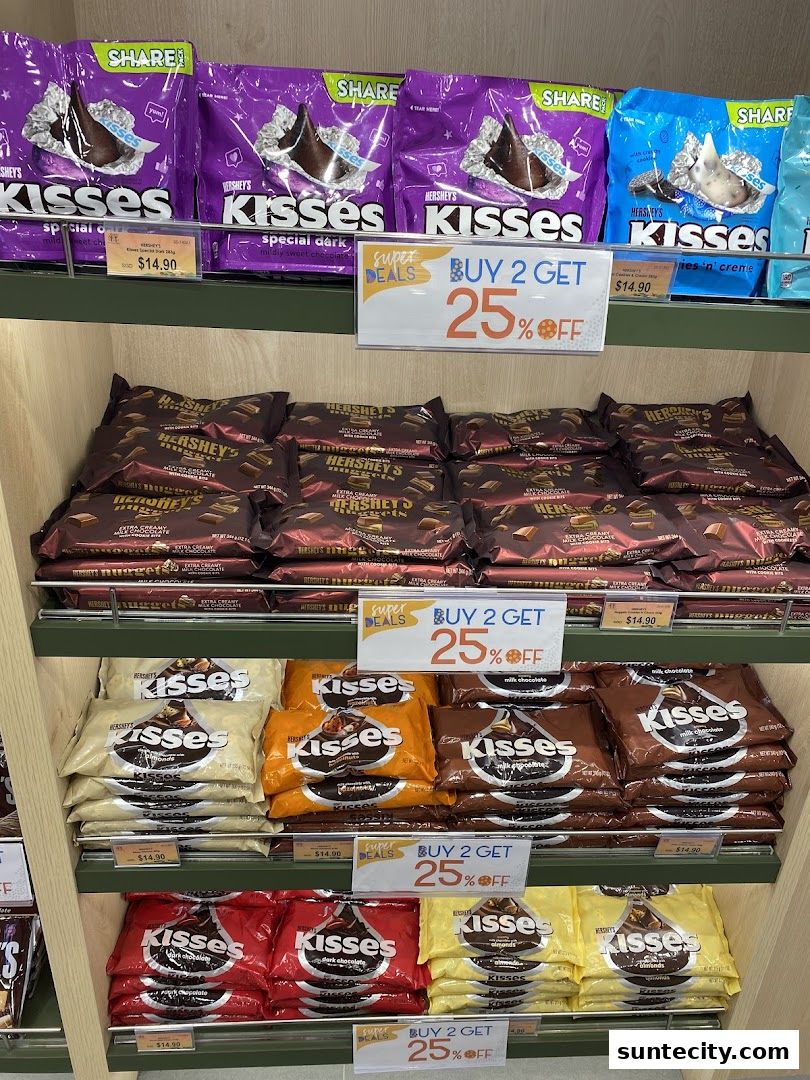 Shelves stocked with various flavors of Hershey's Kisses chocolates, featuring a 'Buy 2 Get 25% Off' promotion.