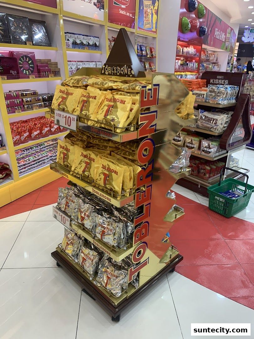 A display stand filled with Toblerone chocolate bars and other confectionery items.