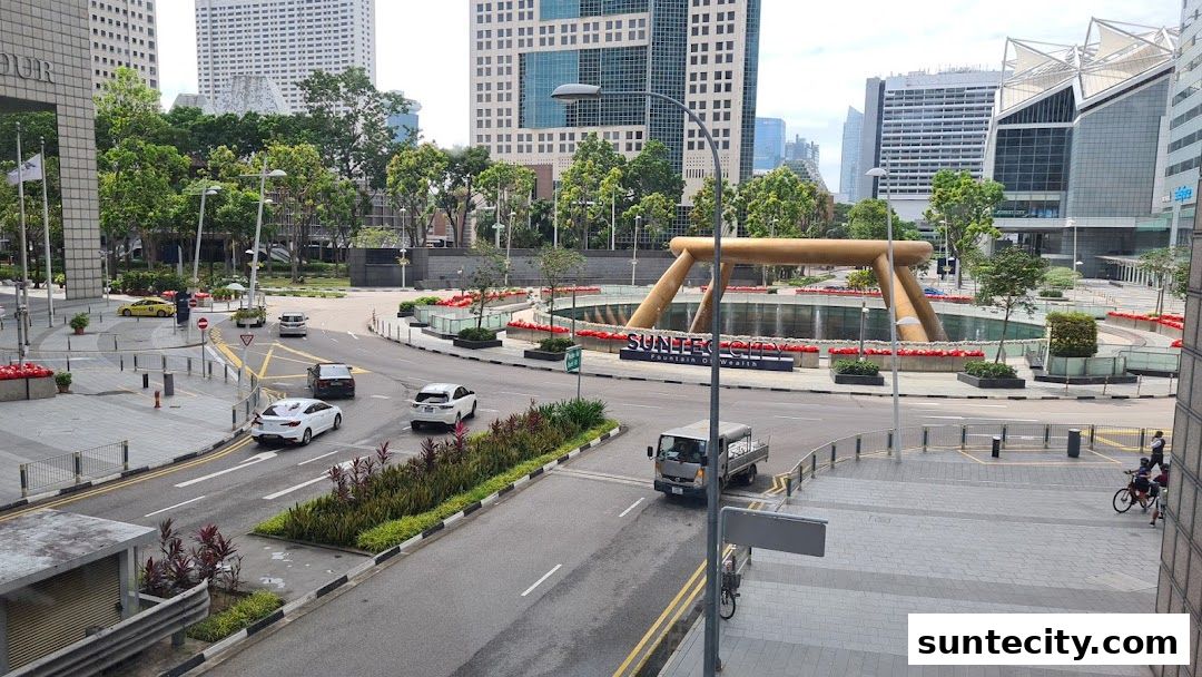 A view of Suntec City Fountain of Wealth with surrounding buildings and traffic.