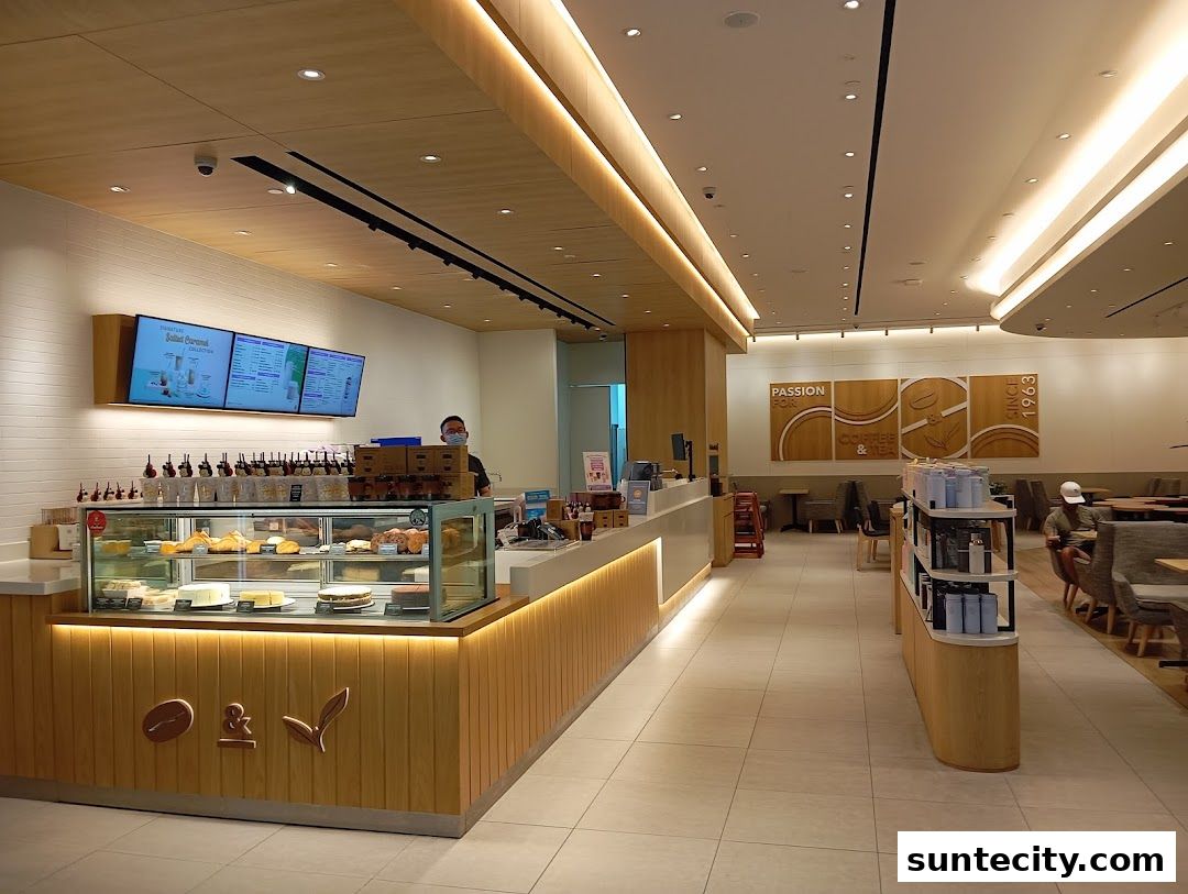 Interior view of The Coffee Bean & Tea Leaf cafe with a counter, display cases, and seating.