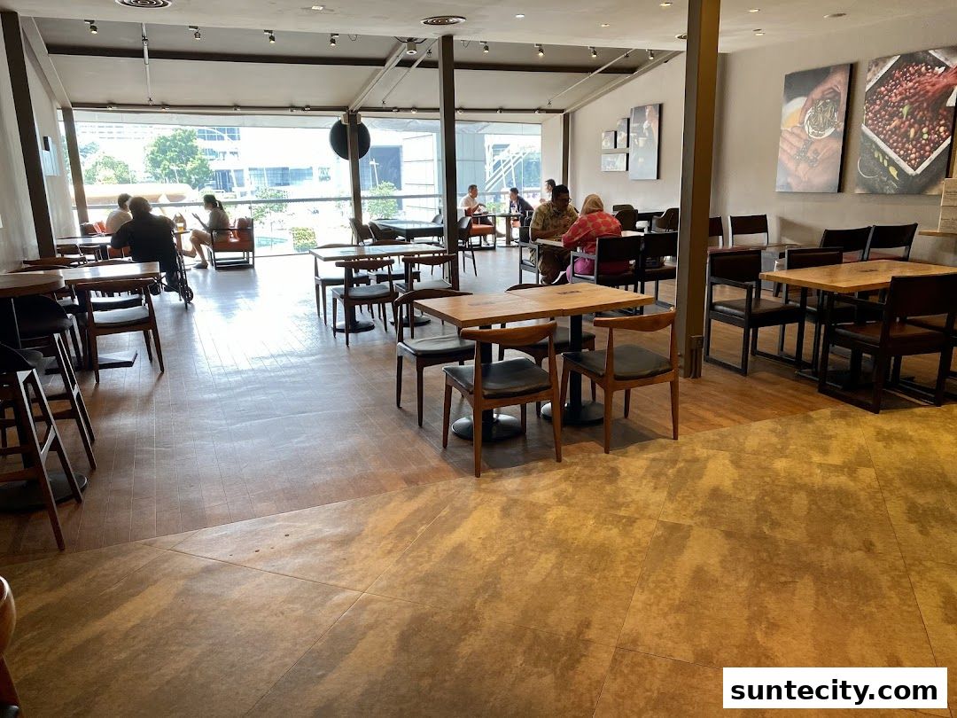 Interior view of The Coffee Bean & Tea Leaf with tables, chairs, and customers enjoying their time.