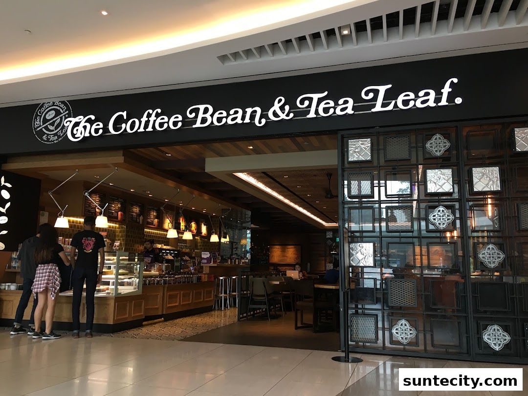 The Coffee Bean & Tea Leaf shop entrance with customers and display cases.
