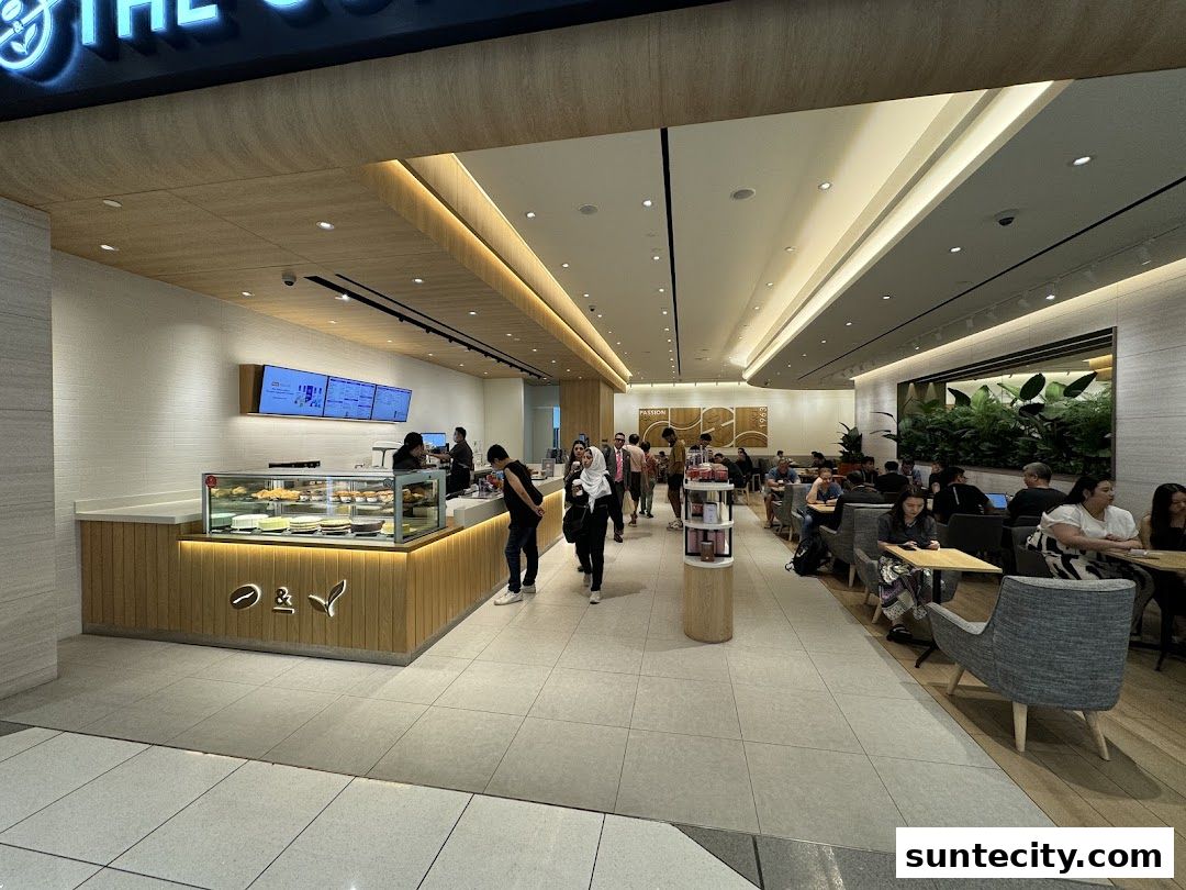Interior of The Coffee Bean & Tea Leaf cafe with customers seated and ordering at the counter.