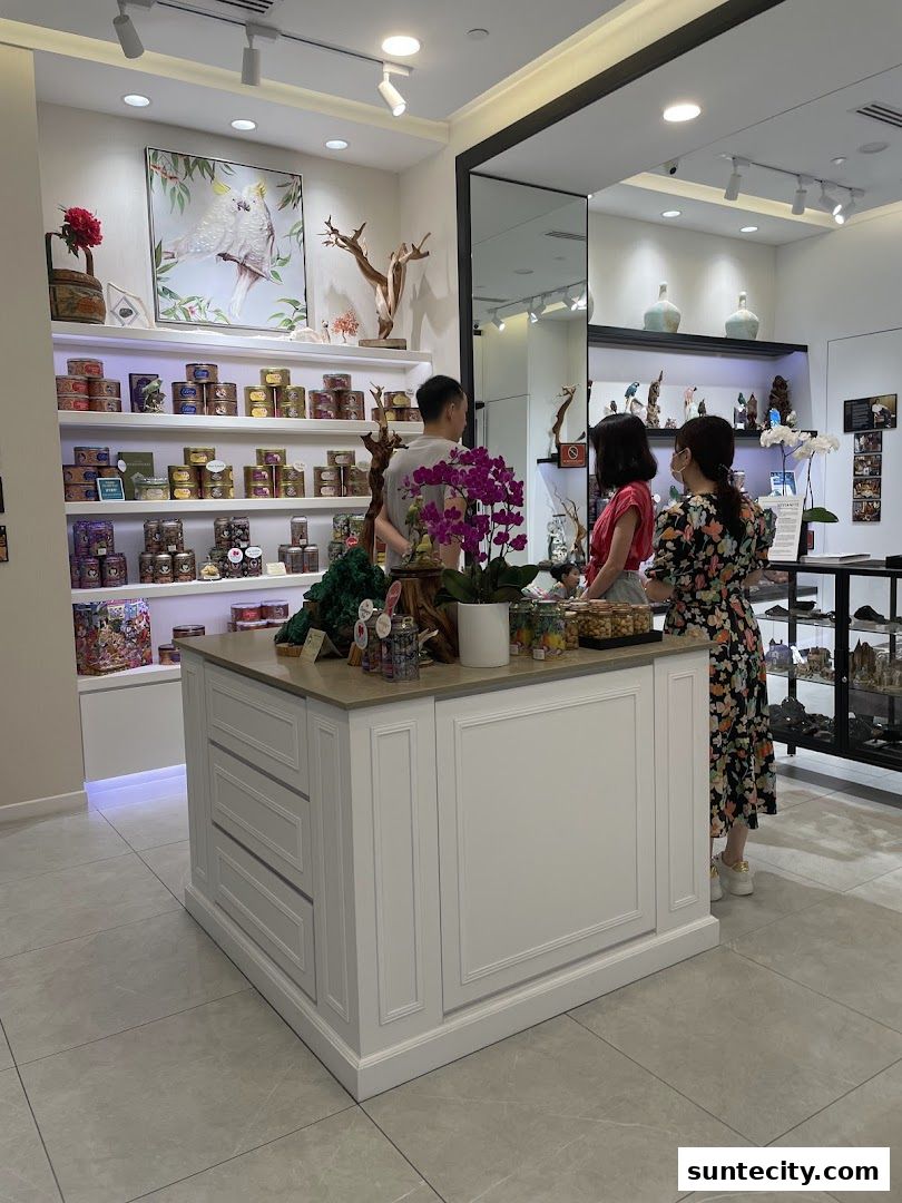 Interior of a shop with shelves stocked with cookies and decorative items, and customers browsing.