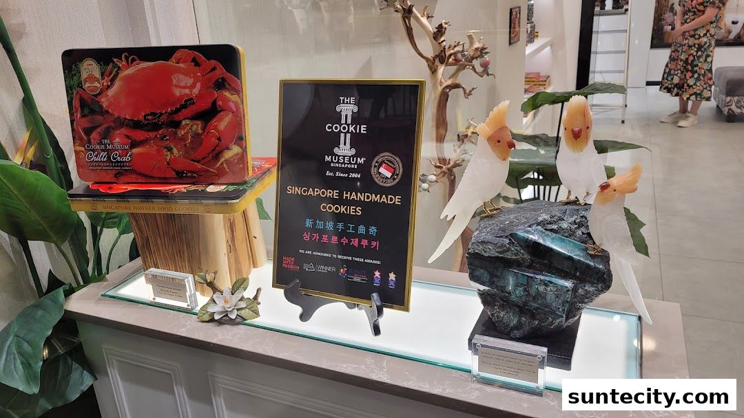Display of Singaporean handmade cookies with chili crab and parrot-themed decorations.
