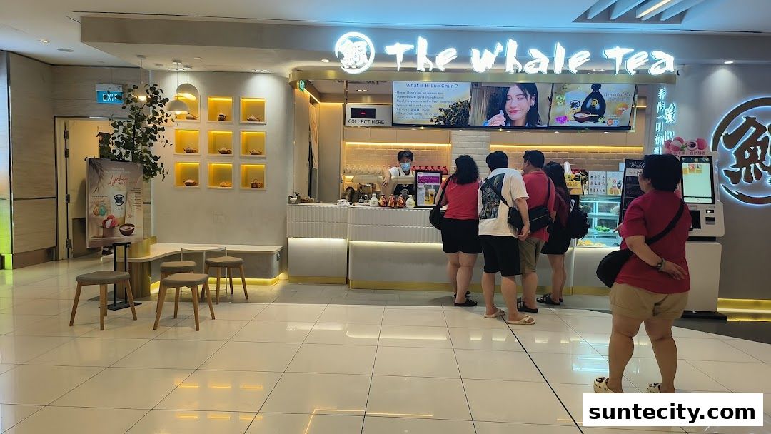 A group of people queuing at The Whale Tea SG counter in Suntec City Mall.