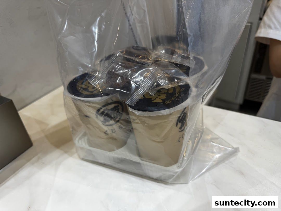 A plastic bag filled with several takeaway drinks from The Whale Tea.
