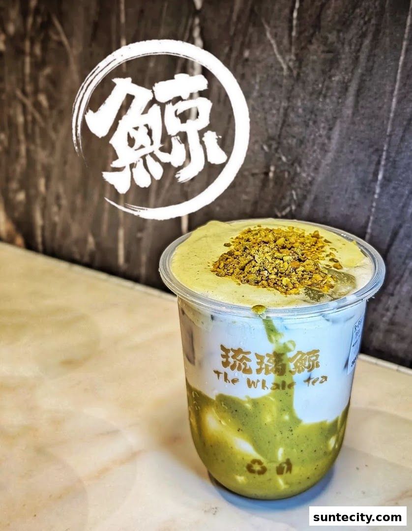 A delicious-looking matcha drink with cream topping and crunchy bits from The Whale Tea.