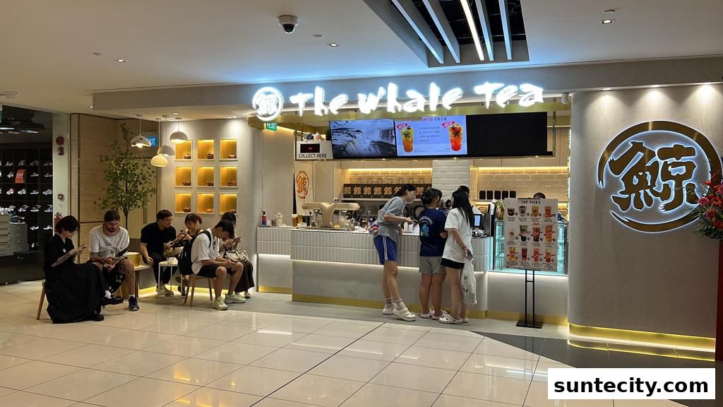 The Whale Tea SG shop front with customers waiting and a menu displayed.